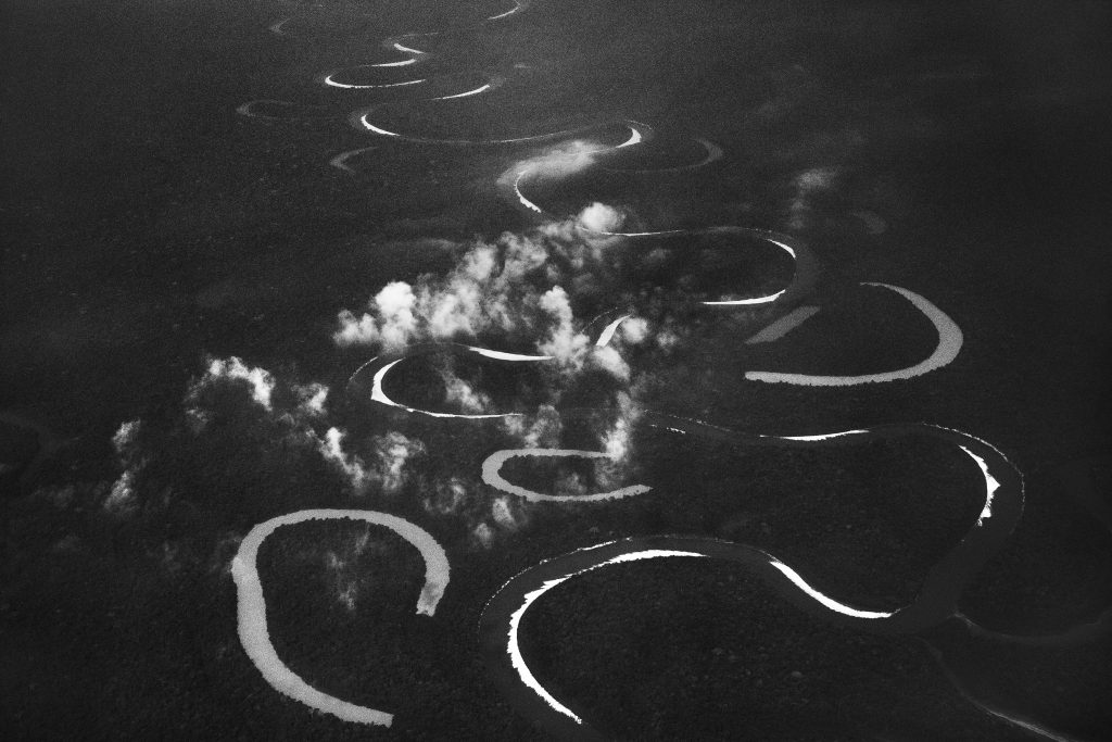Vista aérea do rio Jutaí, que por avançar em uma área extremamente plana, serpenteia traçando curvas pela floresta. Estado do Amazonas, 2017. Sebastião Salgado.